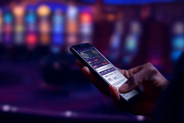 DB9 Mobile App — Your complete hub for casino and sports A man focused on his laptop with live stats in the background, highlighting the dedicated sports and gaming features of the DB9 mobile app.